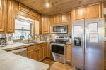 Kitchen showing range & refrigerator